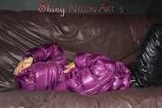 Watching sexy Sandra wearing a black rain pants and a purple down jacket playing with the closed hood (Pics)