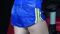 Watching sexy Sandra wearing a sexy blue/yellow shiny nylon shorts and a blue rain jacket during her workout (Video)