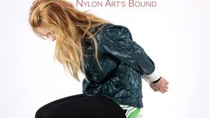 Samantha bound and gagged in a green shiny nylon shorts with green rain jacket and lycra leggings