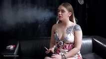 Tattooed girl is smoking a marlboro red
