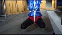 Sonja tied with ropes overhead and gagged with a clothgag wearing sexy black leather pants with a red shiny nylon shorts over it and a special blue down jacket (Video)