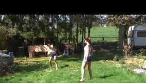 Jill and a friend of her playing soccer in the garden while wearing shiny nylon shorts (Video)