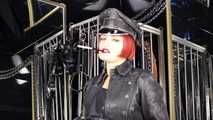 Mistress Tokyo smoking cigarette in leather, gloves and Muir Cap; fetish, POV