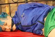 Mara tied and gagged on a princess bed in an old cellar wearing an supersexy shiny green nylon shorts and a blue rain jacket (Pics)