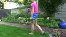 Watch Maly in her shiny nylon Shorts enjoying the warm Weather in the Garden