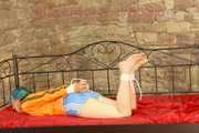 Mara tied and gagged on a princess bed in an old cellar wearing an supersexy shiny lightblue nylon shorts and an orange rain jacket (Pics)