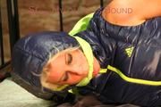 Pia tied, gagged and hooded in a princess bed wearing a sexy black rain pants and a sexy darkblue down vest (Pics)