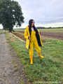 Miss Amira on the road in a Frisian mink, yellow rain dungarees and rubber boots