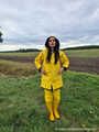 Miss Amira on the road in a Frisian mink, yellow rain dungarees and rubber boots