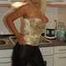 Natural busty Martina posing in a golden corsage, black leggins, pantyhose and heels in the kitchen