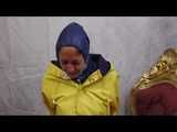 Miss Scarlett in layers of nylon raingear, a friesennerz and hard bound and gagged