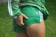 Watching sexy Sandra wearing a sexy green shiny nylon shorts and a green shiny nylon rain jacket enjoying the garden shower (Pics)