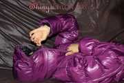 Watching sexy Sandra wearing a black rain pants and a purple down jacket playing with the closed hood (Pics)