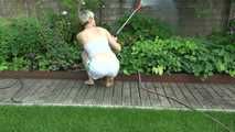 Sexy Sonja wearing a *white* shiny nylon shorts with a white top durig watering the garden (Video)