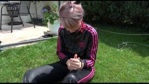 Mara ties and gagges herself in the garden wearing an oldschool shiny nylon rainwear combination (Video)