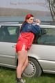 Jill tied and gagged outdoor on a car wearing a sexy red shiny nylon shorts and an oldschool rain jacket (Pics)