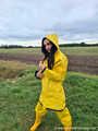 Miss Amira on the road in a Frisian mink, yellow rain dungarees and rubber boots