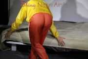 Watching Sandra wearing supersexy shiny nylon rainwear in yellow and orange preparing her bed and lolling in it with this shiny rainwear (Pics)