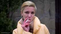 Short cut hair blonde girl is smoking all white 120mm cigarettes