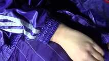 Sandra preparing her shiny nylon bed wearing sexy purple shiny nylon shorts and a purple shiny nylon rain jacket (Video)