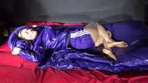 Sandra preparing her shiny nylon bed wearing sexy purple shiny nylon shorts and a purple shiny nylon rain jacket (Video)