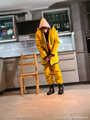 Miss Lara in nylon rain suit and yellow rain dungarees is bound and gagged