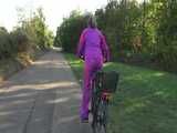 Watch Sandra riding her Bike in her sexy pink shiny nylon Rainsuit