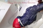 Jill tied and gagged on a shower with cuffs wearing a sexy red shiny nylon shorts and a black rain jacket (Pics)