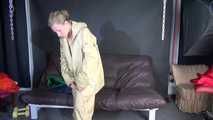 Watching sexy Sandra putting on three rainwear combinations one over the other, hooded (Video)