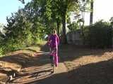 Watch Sandra riding her Bike in her sexy pink shiny nylon Rainsuit