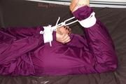 Shelly tied and gagged in a shiny nylon rainauit 