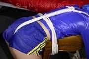 Watching sexy Sonja wearing a sexy shiny nylon shorts in blue and a blue rain jacket being tied and gagged on a stool with ropes and a clothgag (Pics)