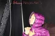 Watching sexy Sandra wearing a black rain pants and a purple down jacket playing with the closed hood (Pics)