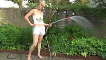 Sexy Sonja wearing a *white* shiny nylon shorts with a white top durig watering the garden (Video)