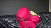 Pia wearing a supersexy black rain pants and a pink down jacket tied, gagged and hooded with cloth (Video)