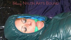 Pia tied, gagged and hooded on bed wearing a sexy black shiny rain pants and a green down jacket (Pics)
