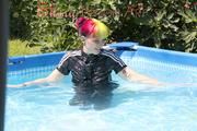 Mara sunbathing and swimming in the pool wearing a supersexy black adidas shiny nylon rainwear (Pics)