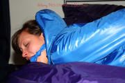 Alina tied and gagged in a shiny skisuit