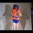 Mara wearing a sexy shiny swimsuit and a shiny nylon shorts trying on a lifevest (Video)