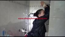 Jill tied and gagged taking a shower wearing sexy shiny nylon shorts and a rain jacket (Video)