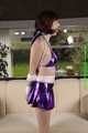 Danny bound in a shiny purple Skirt and Bra, gagged with a Silkscarf