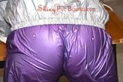 Jill tied and gagged on a table wearing a shiny purple/silver PVC sauna suit (Pics)