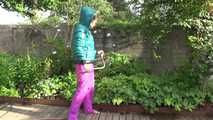 Watching Sandra taking a sun bath and watering the garden the pest plants wearing a sexy purple rain pants and a green down jacket (Video)