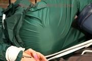 Pia tied, gagged and hooded in a princess bed wearing sexy shiny green rainwear (Pics)