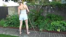 Sexy Sonja wearing a *white* shiny nylon shorts with a white top durig watering the garden (Video)