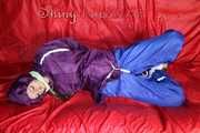 SANDRA being tied and gagged on a sofa with ropes and a clothgag wearing a sexy blue shiny nylon rain pants and a purple rain jacket  Part 2 (Pics)