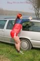 Jill tied and gagged outdoor on a car wearing a sexy red shiny nylon shorts and an oldschool rain jacket (Pics)