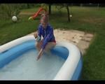 Mara in the swimming pool wearing a sexy red shiny nylon shorts and a lightblue sihny rain jacket playing with the water (Video)