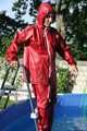 Watch Sandra enjoying the Summer in her shiny nylon Rainwear in the Garden