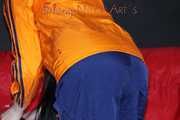 Sexy Lucy wearing a blue shiny nylon rain pants and an orange rain jacket sorting shiny nylon shorts (Pics)